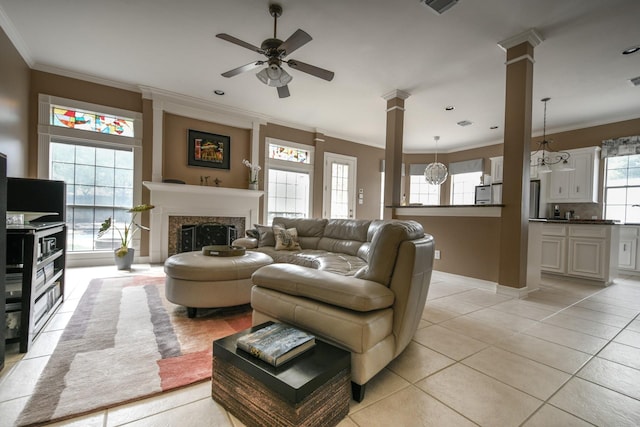 2910 Lara Brook Ct, Katy, TX 77494 - living room featuring a ceiling fan, decorative columns, light tile patterned flooring, crown molding, and a premium fireplace