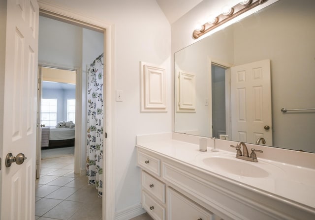 2910 Lara Brook Ct, Katy, TX 77494 - ensuite bathroom featuring vanity, tile patterned flooring, and baseboards