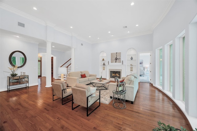 522 Rancho Bauer Dr, Houston, TX 77079 - living room featuring plenty of natural light, built in shelves, a lit fireplace, wood finished floors, and recessed lighting