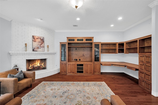 522 Rancho Bauer Dr, Houston, TX 77079 - living room featuring ornamental molding, dark wood-style flooring, a fireplace, and recessed lighting