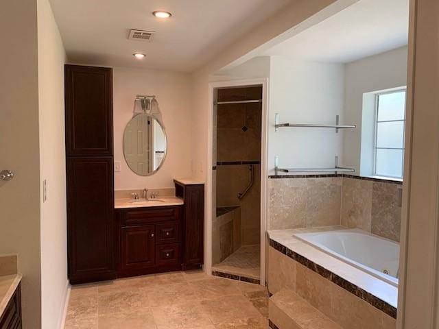 full bath featuring vanity, a bath, a stall shower, and recessed lighting
