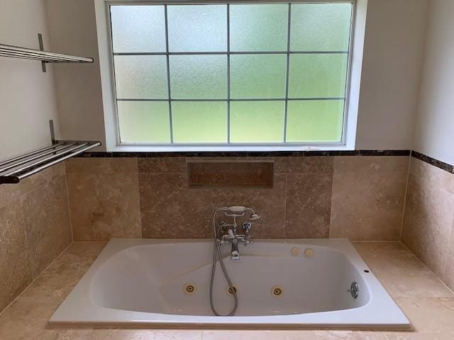 full bath featuring a tub with jets
