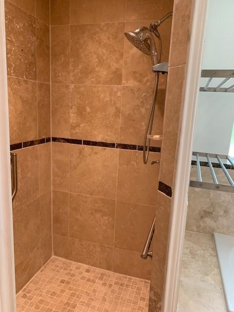 full bath with a tile shower