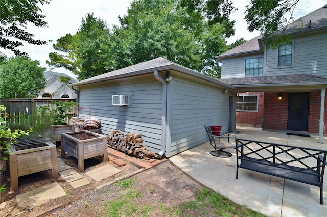 18411 Arrow Flint Cv, Houston, TX 77084 - view of patio / terrace with a vegetable garden and a wall mounted air conditioner