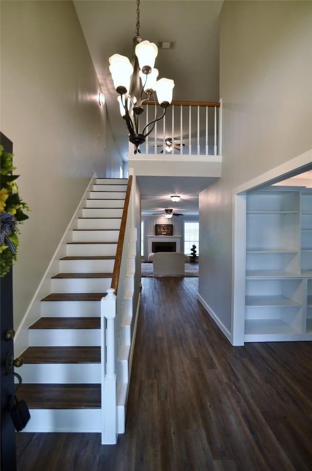 18411 Arrow Flint Cv, Houston, TX 77084 - stairway with a high ceiling, a chandelier, wood finished floors, and baseboards