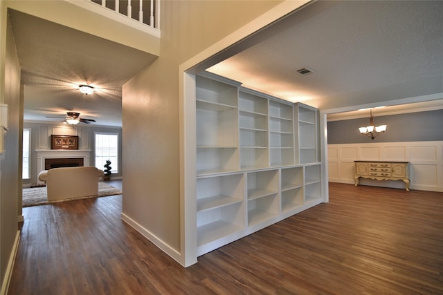 18411 Arrow Flint Cv, Houston, TX 77084 - corridor with a chandelier, dark wood-type flooring, baseboards, a decorative wall, and a textured ceiling
