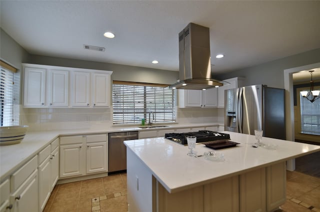 18411 Arrow Flint Cv, Houston, TX 77084 - kitchen featuring stainless steel appliances, island exhaust hood, a sink, light tile patterned floors, and light countertops