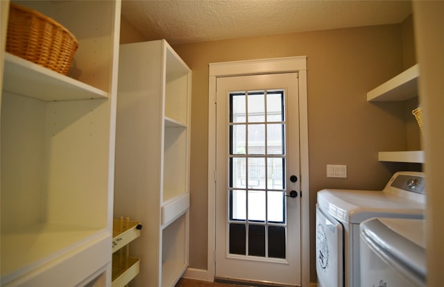 18411 Arrow Flint Cv, Houston, TX 77084 - laundry area with washer and dryer and a textured ceiling