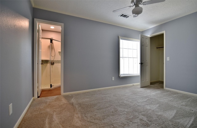 18411 Arrow Flint Cv, Houston, TX 77084 - unfurnished bedroom with crown molding, carpet, a textured ceiling, ensuite bath, and baseboards