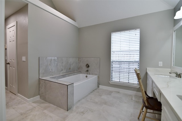 18411 Arrow Flint Cv, Houston, TX 77084 - full bathroom with vaulted ceiling, a garden tub, baseboards, and double vanity