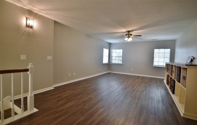 18411 Arrow Flint Cv, Houston, TX 77084 - unfurnished living room with dark wood finished floors, ceiling fan, a textured ceiling, and baseboards