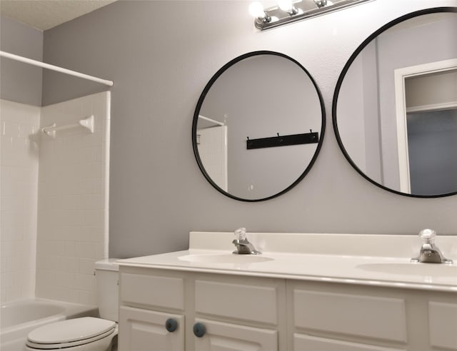 18411 Arrow Flint Cv, Houston, TX 77084 - bathroom featuring toilet, double vanity, and bathing tub / shower combination