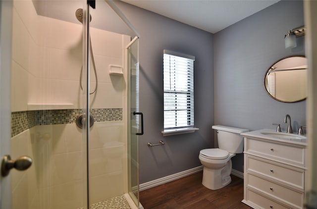 18411 Arrow Flint Cv, Houston, TX 77084 - bathroom featuring a stall shower, wood finished floors, toilet, vanity, and baseboards