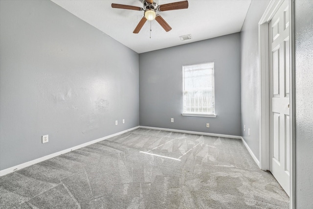 spare room featuring a ceiling fan, carpet floors, and baseboards