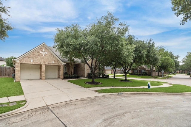 view of front of house with brick siding, driveway, and a garage