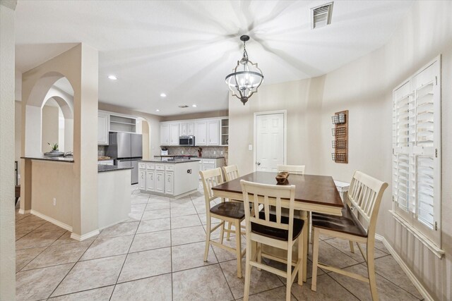 dining area with light tile patterned floors, recessed lighting, and baseboards