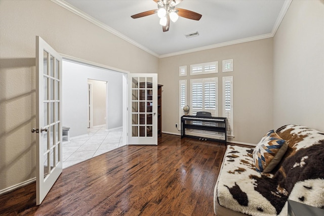 living area with french doors, ornamental molding, wood finished floors, ceiling fan, and baseboards