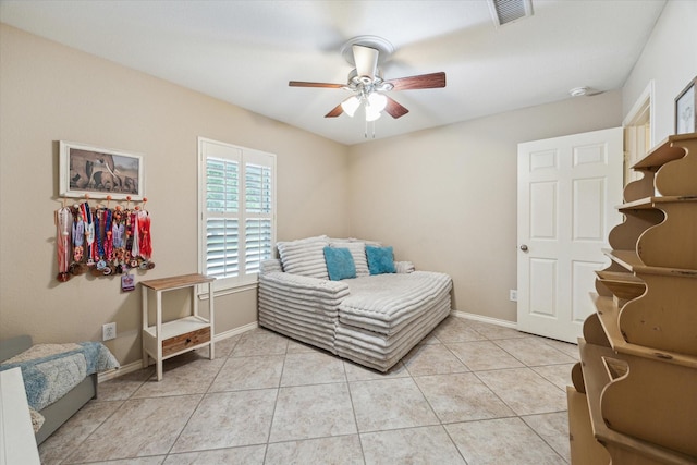 bedroom featuring baseboards, light tile patterned floors, and ceiling fan