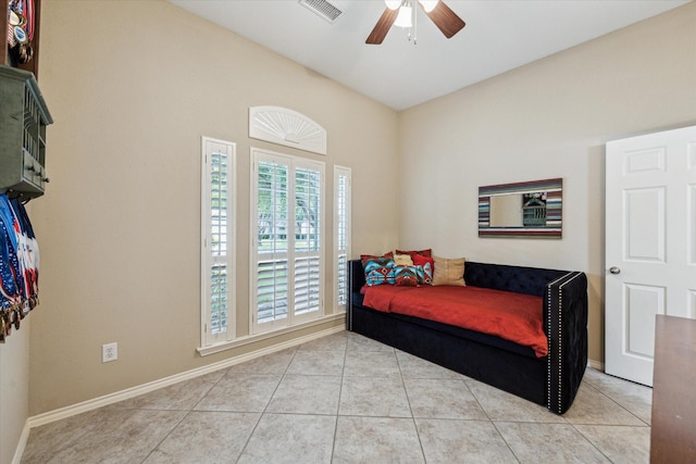 bedroom with light tile patterned floors, baseboards, and a ceiling fan