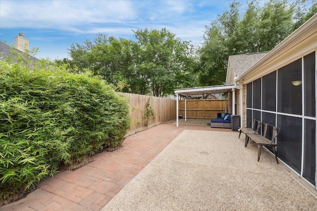 view of patio / terrace with a fenced backyard and a sunroom