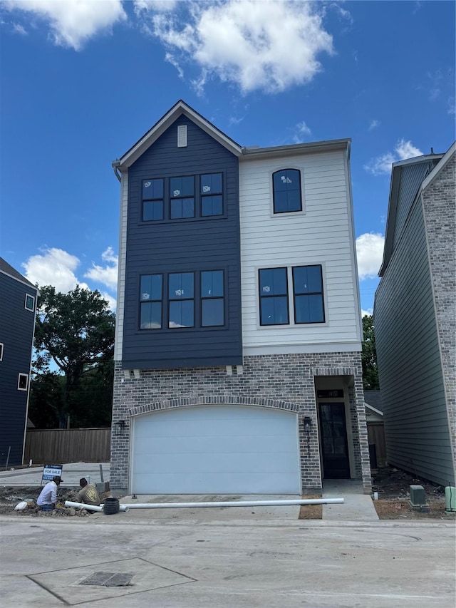 1711 Bologna Ln, Houston, TX 77055 - view of front of home featuring a garage and brick siding