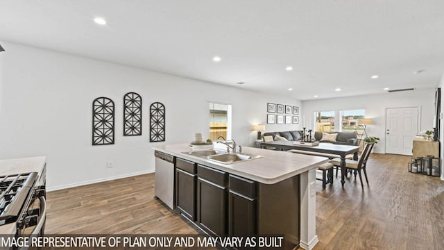 5427 Magnolia Heath Ln, Spring, TX 77373 - kitchen with a sink, appliances with stainless steel finishes, wood finished floors, light countertops, and healthy amount of natural light