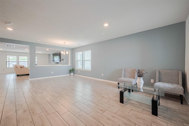 20864 Sheffield Park Dr, Porter, TX 77365 - sitting room with a chandelier, recessed lighting, baseboards, and wood tiled floors