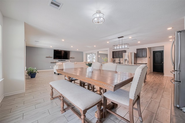 20864 Sheffield Park Dr, Porter, TX 77365 - dining space featuring wood tiled floors, baseboards, and recessed lighting