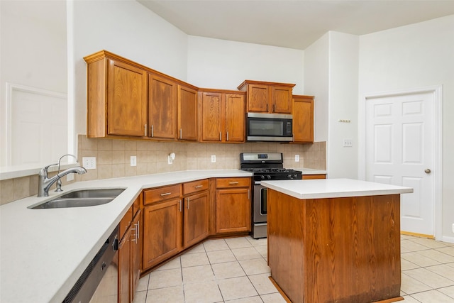 kitchen with stainless steel appliances, a sink, light tile patterned flooring, tasteful backsplash, and light countertops