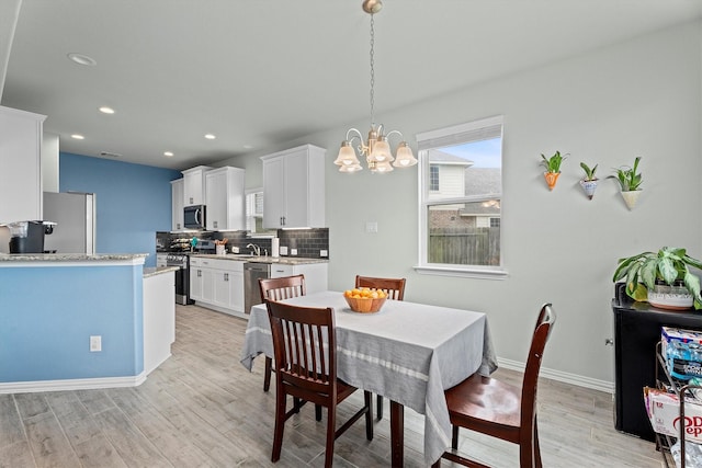 107 San Jacinto Dr, Baytown, TX 77523 - dining room featuring light wood-style flooring, a chandelier, recessed lighting, and baseboards