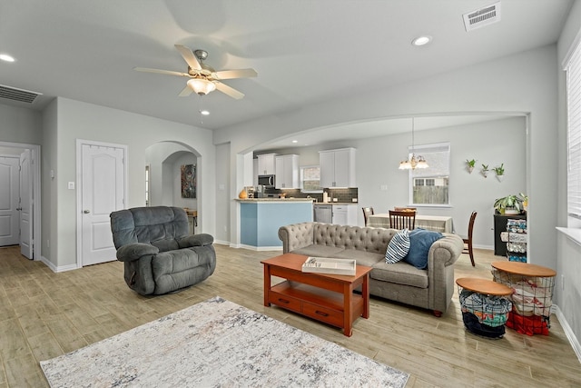 107 San Jacinto Dr, Baytown, TX 77523 - living area featuring arched walkways, light wood-style floors, ceiling fan, and recessed lighting