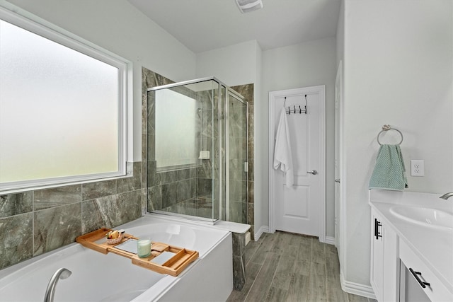 107 San Jacinto Dr, Baytown, TX 77523 - full bathroom featuring a shower stall, a bath, vanity, and wood finished floors