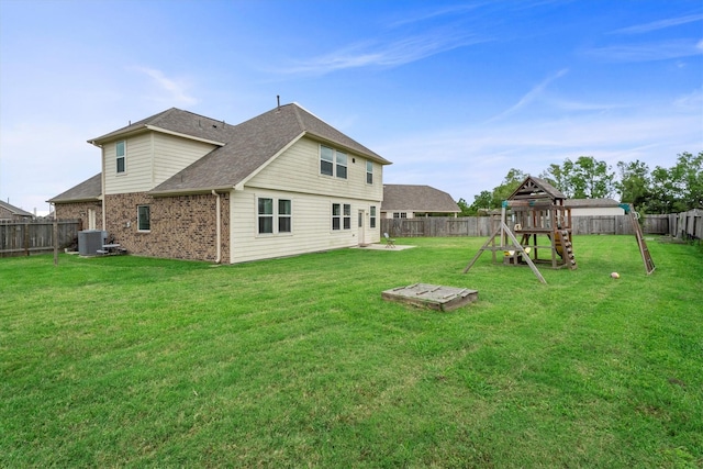 107 San Jacinto Dr, Baytown, TX 77523 - rear view of house with a playground, central AC, brick siding, and roof with shingles