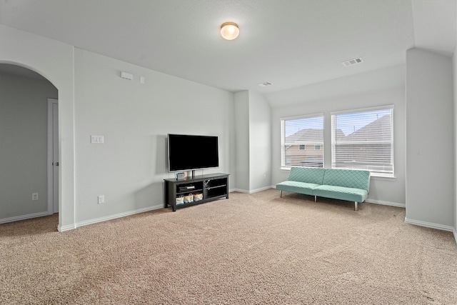 107 San Jacinto Dr, Baytown, TX 77523 - living area featuring carpet flooring, arched walkways, baseboards, and vaulted ceiling
