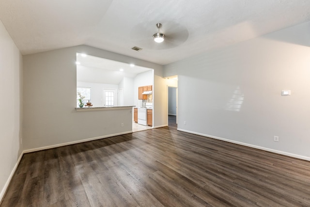 14089 Broken Arrow Dr, Willis, TX 77378 - unfurnished living room with ceiling fan, vaulted ceiling, dark wood finished floors, and baseboards