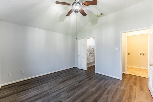 14089 Broken Arrow Dr, Willis, TX 77378 - unfurnished bedroom featuring dark wood-style floors, vaulted ceiling, baseboards, and a ceiling fan