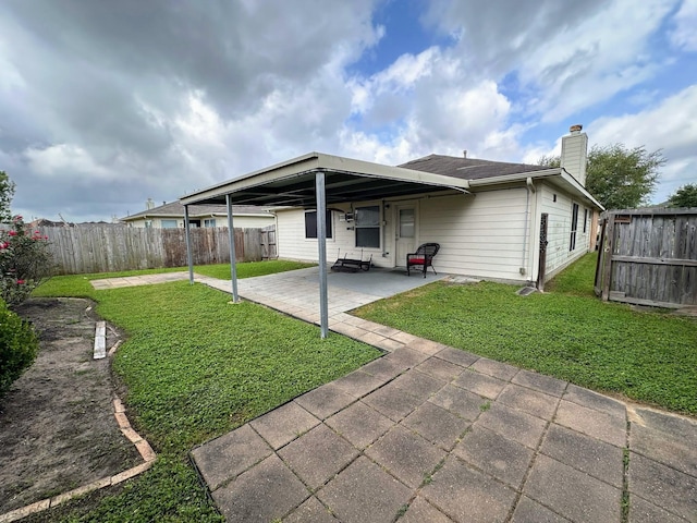 back of property featuring a patio and a chimney