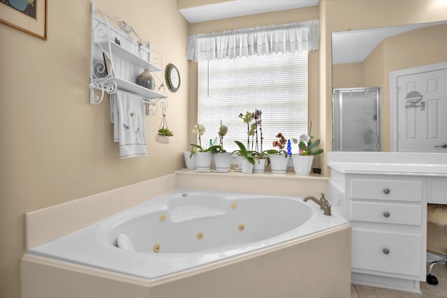 bathroom featuring a stall shower, a tub with jets, and tile patterned floors