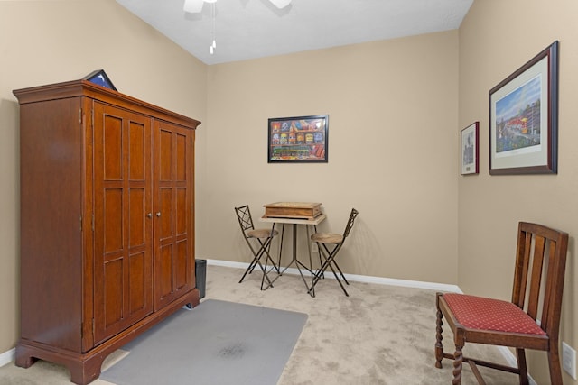 office area featuring light colored carpet, ceiling fan, and baseboards