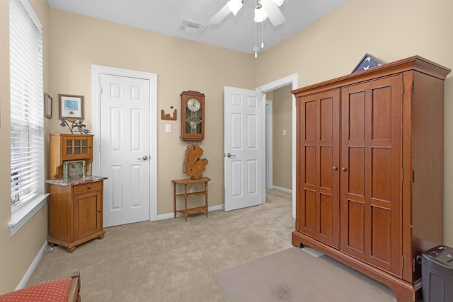 bedroom with light carpet, baseboards, and ceiling fan