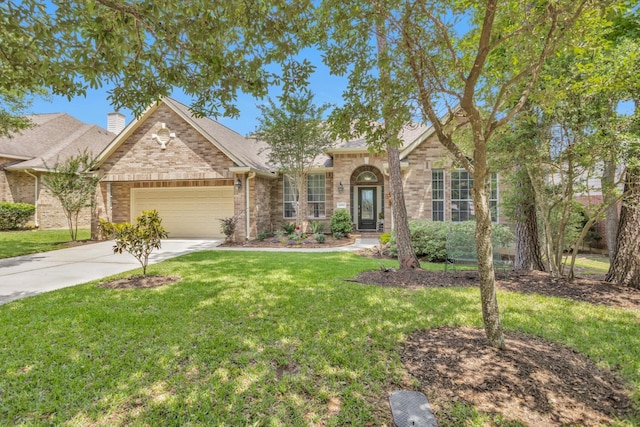 view of front of home featuring an attached garage, driveway, a front yard, and brick siding