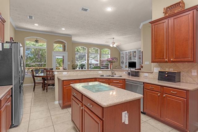 kitchen with black refrigerator with ice dispenser, ceiling fan, a sink, a peninsula, and healthy amount of natural light