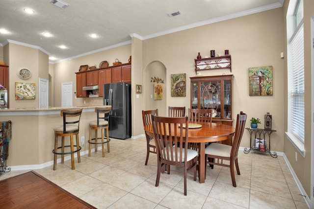 dining area with crown molding, recessed lighting, light tile patterned flooring, and baseboards