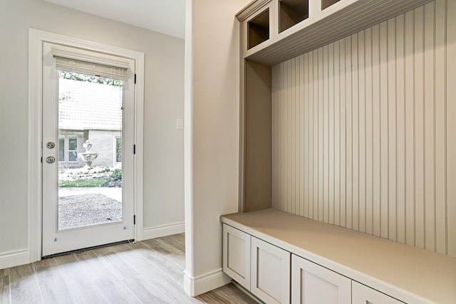 mudroom with light wood-style floors and baseboards
