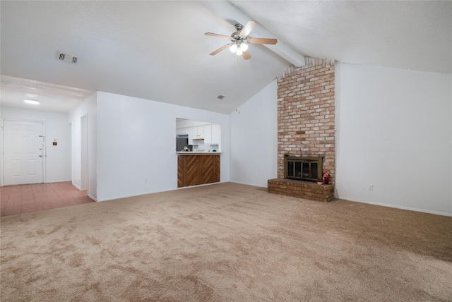 unfurnished living room featuring carpet, ceiling fan, a fireplace, and baseboards