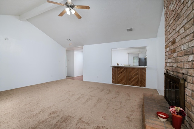 unfurnished living room featuring a brick fireplace, carpet flooring, and a ceiling fan
