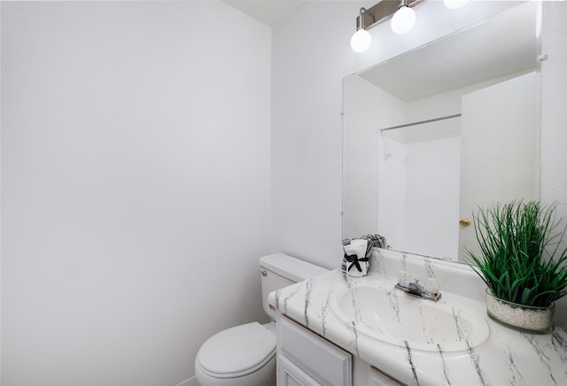 full bathroom featuring toilet, vanity, and a shower