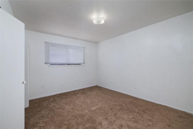 carpeted spare room with baseboards