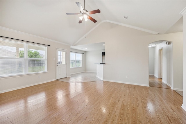 243 S Lantana Cir, Sealy, TX 77474 - unfurnished living room with arched walkways, ceiling fan, light wood-style flooring, high vaulted ceiling, and baseboards