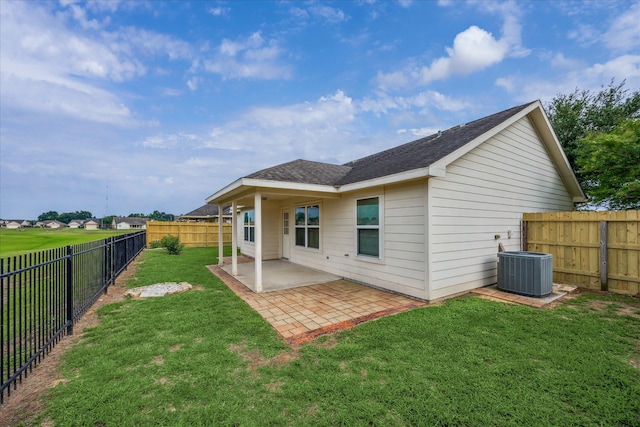 243 S Lantana Cir, Sealy, TX 77474 - rear view of house with a patio, roof with shingles, and central AC